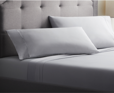 Two Malouf pillows on a bed.